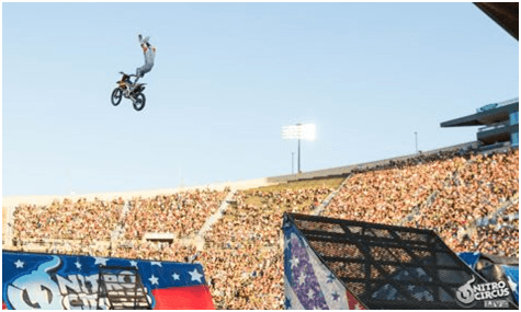 A Dirt Bike Flys Through The Air at the Nitro Circus