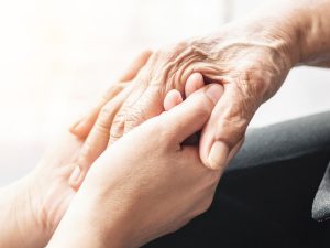 Photograph of young and old hands holding each other