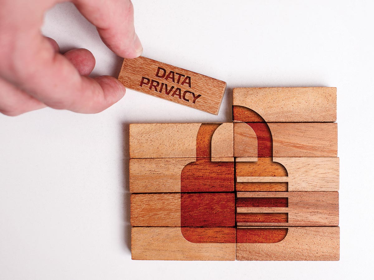 Photo of a woodblock puzzle revealing a lock to show the concept of data privacy