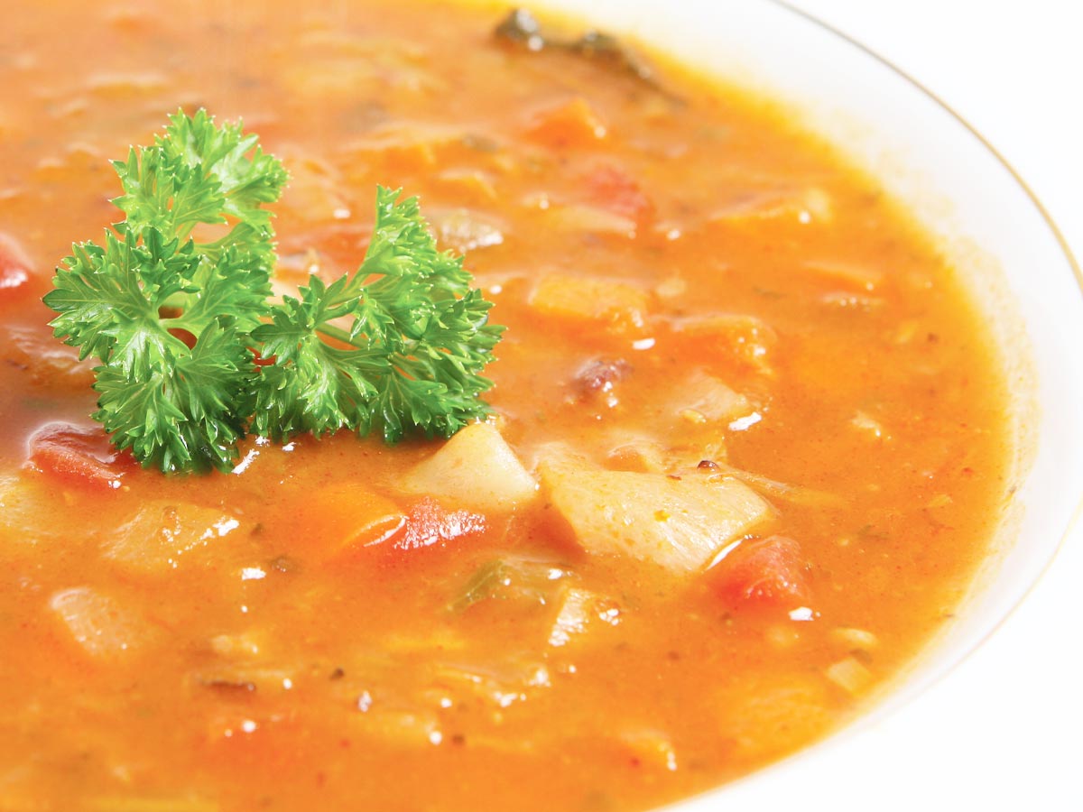 Closeup photo of a bowl of vegetable soup.