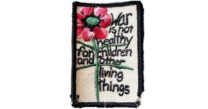 Photo of a patch that reads War is not healthy for children and other living things