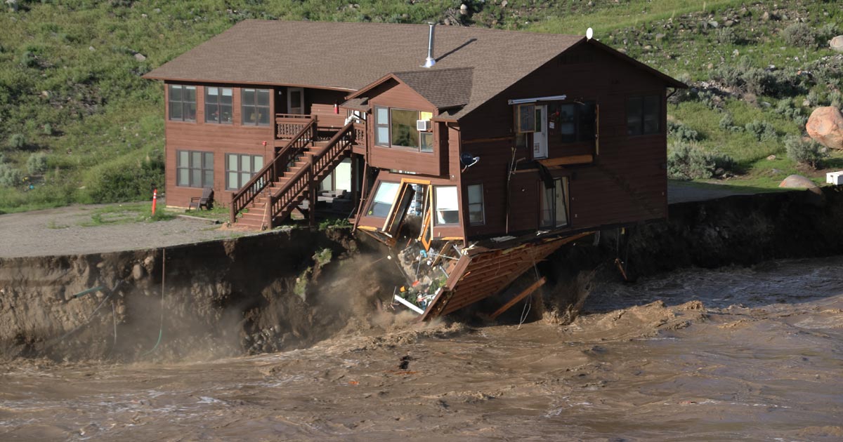 Photo of National Park employee housing getting swept downstream in the 2022 Yellowstone flood.