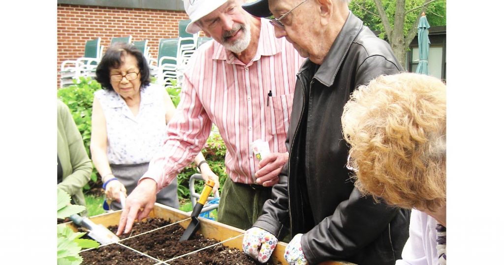 Mel Bartholemew teaching seniors Square Foot Gardening — a method for growing more in less space.