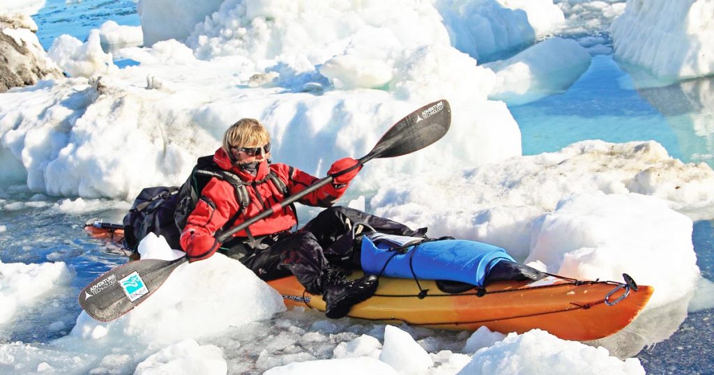 Photo of Montana adventurer/explorer Jon Turk kayaking through the icy waters around Ellesmer Island, close to the North Pole