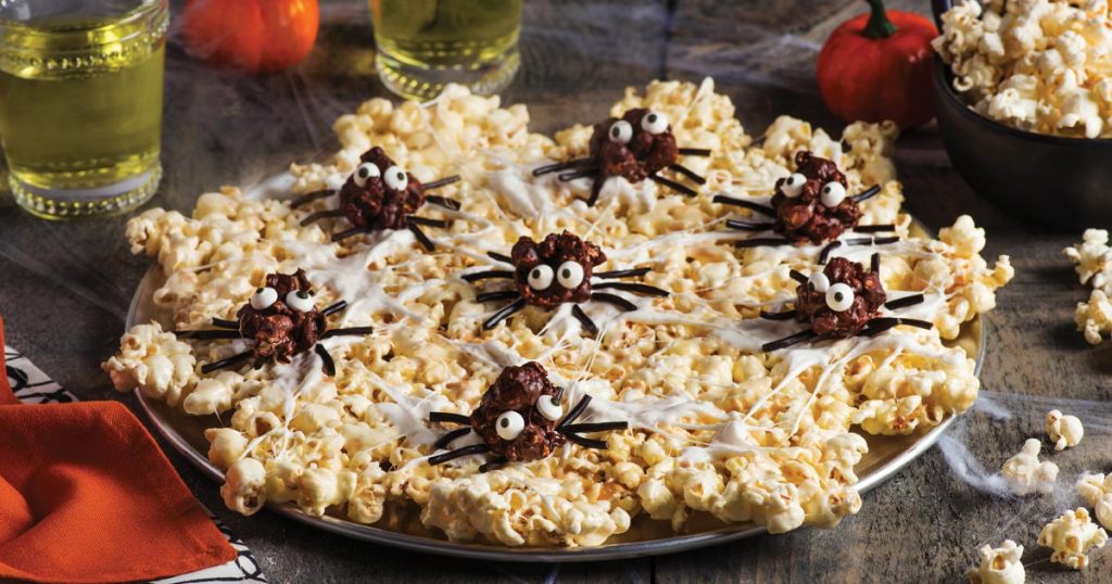 Photo of spooky snacks: chocolate spiders on popcorn