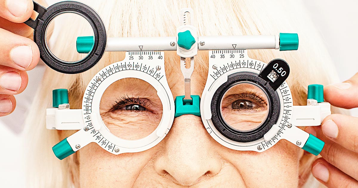 Closely cropped image of an elder woman having an eye exam