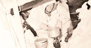 Forceman of the First Special Service Force preparing rations in an improvised shelter during cold weather survival training, Blossburg, Montana, United States, January 1943. (Library and Archives Canada Photo, No. 3378685)