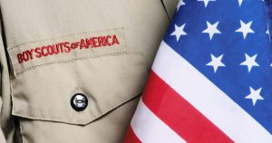 Troop 38 Closeup photo of a boy scout uniform and America Flag