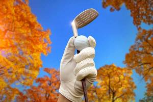 Gloved hand holding golf ball